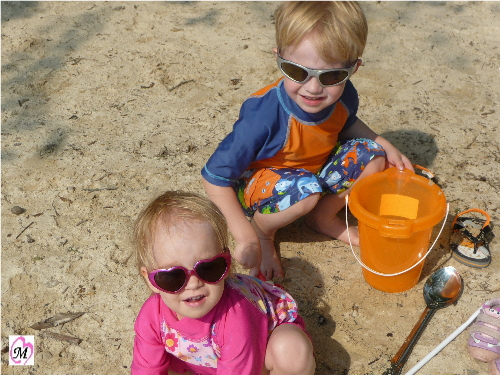 kids playing at a lake beach
