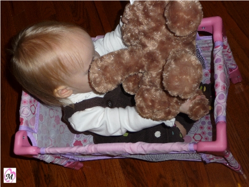 1 year old in doll crib