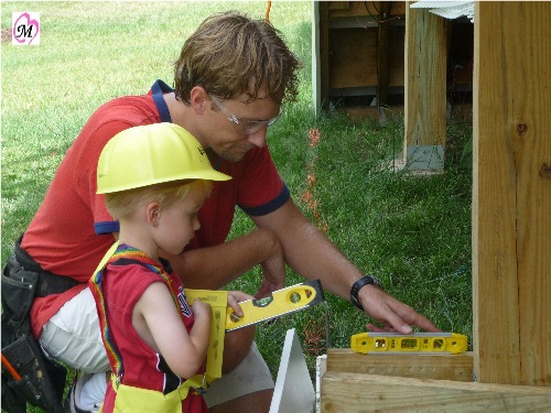 4 year old helping daddy build deck