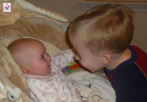 preschooler smiling with baby