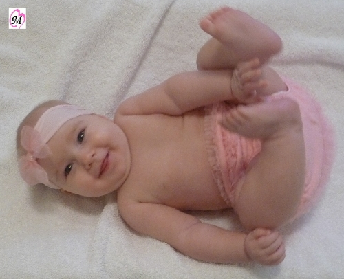 baby playing with feet