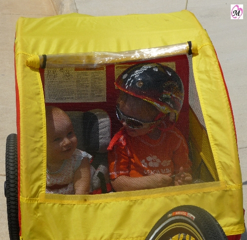 Infant and Toddler riding in Bike Trailer