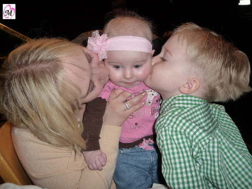 mommy and brother kissing baby sister