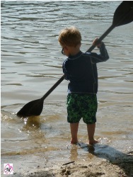 toddler playing with kayak