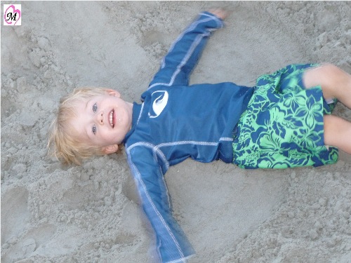 Toddler Laying in Sand