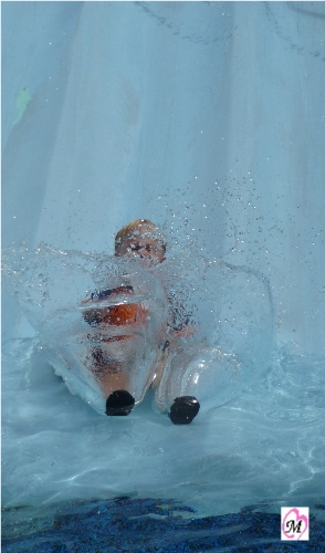 4 year old getting splashed on water slide