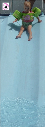 1 year old getting ready to go down water slide