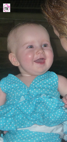 infant smiling while swimming